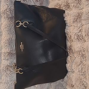 Genuine Coach, black leather purse with gold accents.